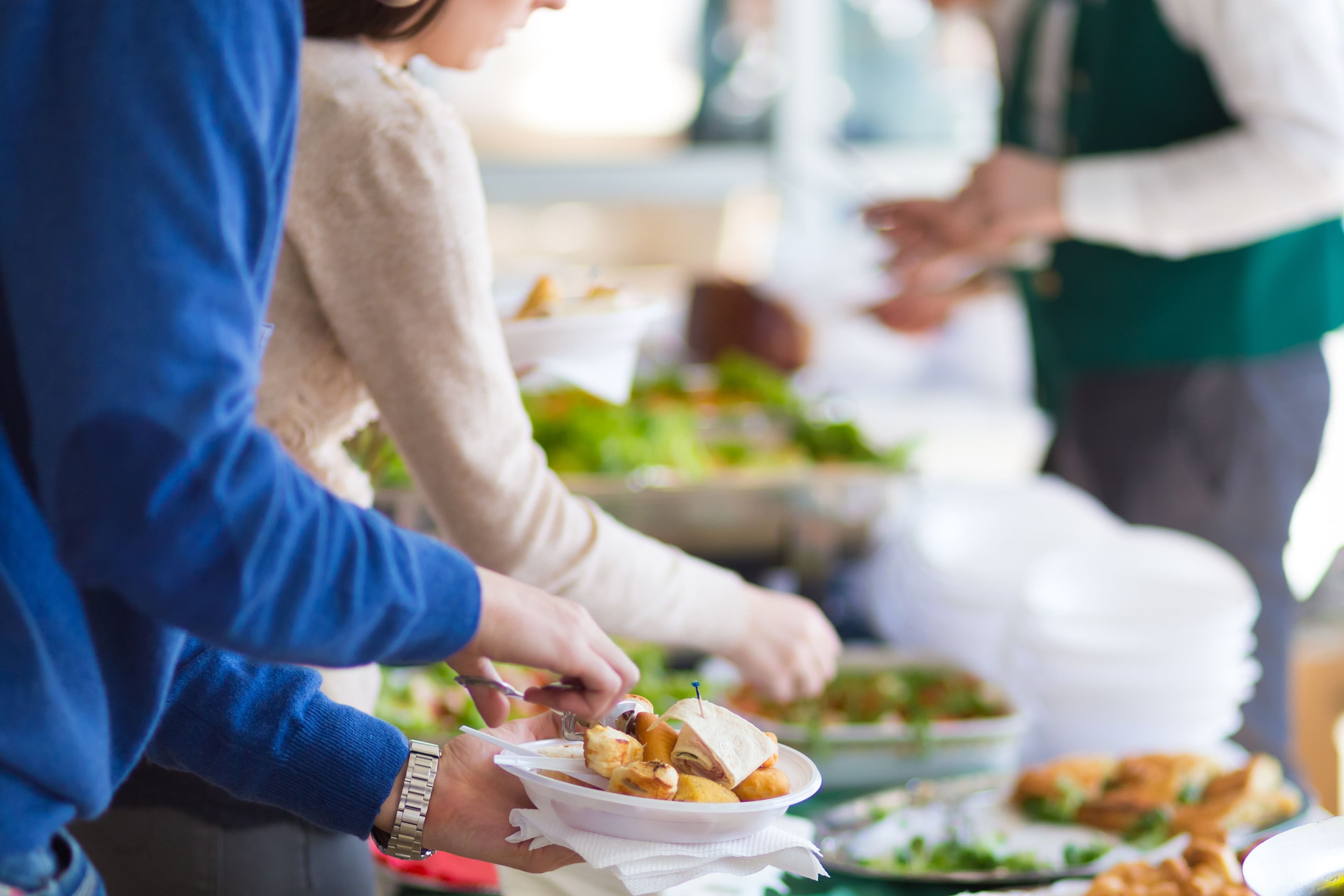 People serving themselves at a buffet